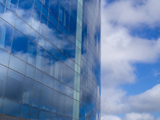 Cloudy sky reflection on the skyscraper windows, close up