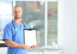 © New Africa - Portrait of medical assistant with stethoscope and clipboard in hospital. Space for text