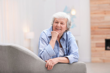 Wall Mural - Portrait of beautiful grandmother in living room