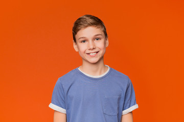 portrait of young boy on orange background
