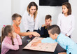 © JackF - Children making move on pre-marked surface of board game