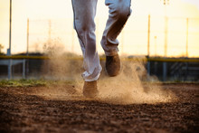 Baseball Player Feet Running To Base On Field, Dirt And Dust Moving From Action Of Athlete.