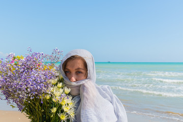 young women with  a bouquet of various flowers