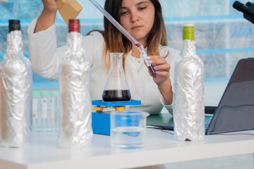 Poster - Young female technician in the quality control laboratory of wine quality inspection