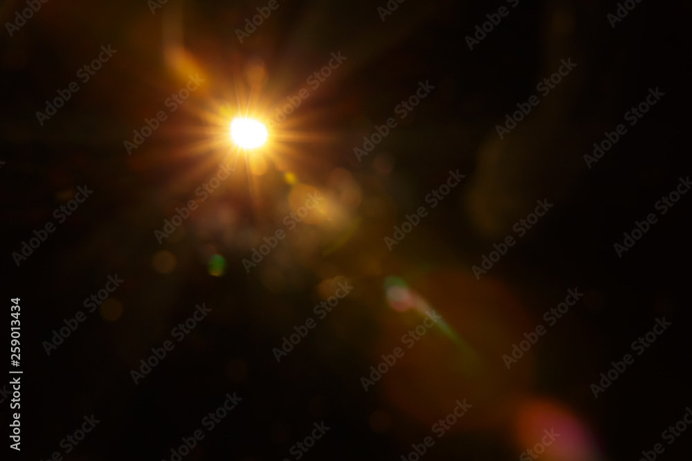 Abstract Natural Sun flare on the black background. - obrazy, fototapety, plakaty 