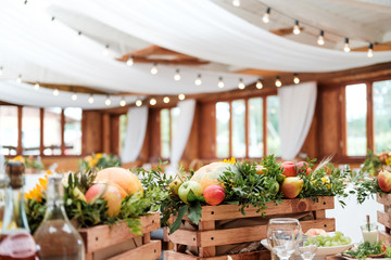 Wall Mural - Bright room with white fabrics and vintage garlands of incandescent bulbs on the ceiling. The decor of the served table, the design of the event.