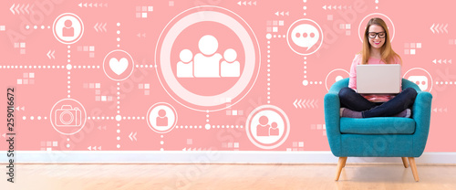 Social media with young woman using her laptop in a chair Canvas