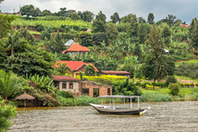 Roof Boat Anchored At The Coast With Rwandan Village In The Background, Kivu Lake, Rwanda
