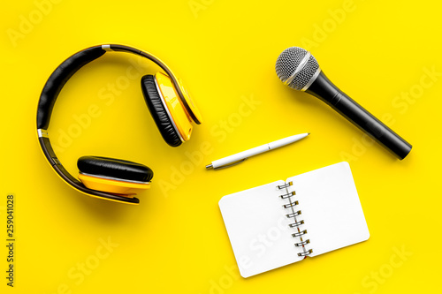 Download Blogger Journalist Or Musician Work Space With Microphone Notebook And Headphones On Yellow Background Top View Mockup Stock Photo Adobe Stock