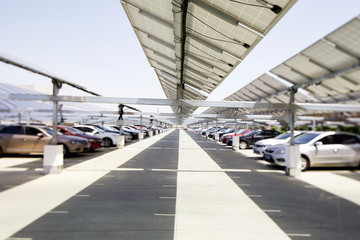 Wall Mural - Many cars are parked under the solar photovoltaic panel