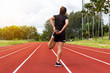 © Surasak - portrait of beautiful young female athlete preparing for running on running track (back view)