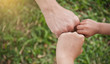 © paulaphoto - Family hands Giving Fist Bump. Successful business teamwork with hands gesture communication over green grass nature background. Family partnership business work strength together harmony concept