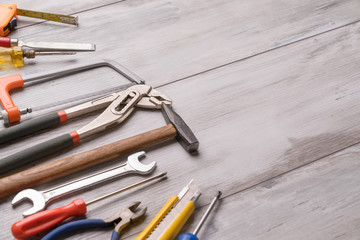 screwdriver,hammer,tape measure and other tool for construction tools on gray wooden background with