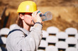 © astrosystem - Construction worker on a heavy site doing hard work and drinking water.