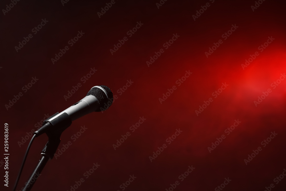 Modern microphone on color background
