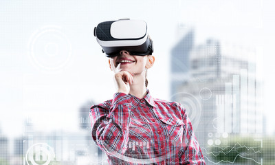 Canvas Print - Girl in checked shirt wearing VR glasses experiencing another reality