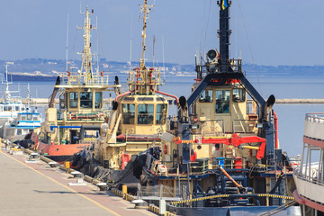 Wall Mural - Tugboats is at the pier in the seaport. Cargo port Odessa, Ukraine