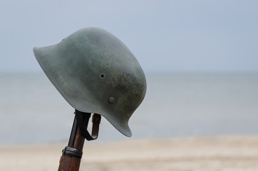 AFTER THE BATTLE - A German soldier's helmet on a rifle