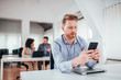 © bnenin - Businessman checking phone in the office.