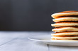 © Mikhaylovskiy  - fresh classic pancake stacked in stack on gray background with place for text