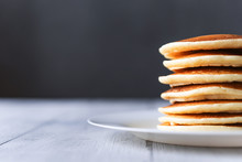fresh classic pancake stacked in stack on gray background with place for text