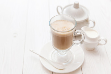 Raf coffee in transparent glass on a light wooden background. Delicious Russian most popular drinks. 