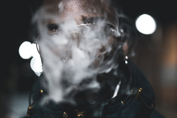 Portrait African-American guy smoking a cigarette