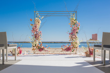 Wall Mural - Event decoration. Wedding chuppa at riverside decorated with fresh flowers. Florist workflow