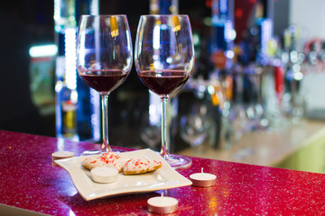 two glasses of wine and heart-shaped cookies. Valentine's Day