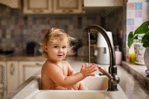 Baby Taking Bath In Kitchen Sink Child Playing With Water