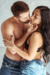 © LIGHTFIELD STUDIOS - handsome and shirtless man hugging beautiful woman in bra in bedroom
