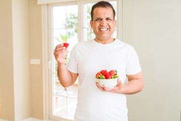 Poster - Middle age man eating strawberry at home