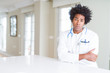 © Krakenimages.com - African American doctor man at the clinic skeptic and nervous, disapproving expression on face with crossed arms. Negative person.