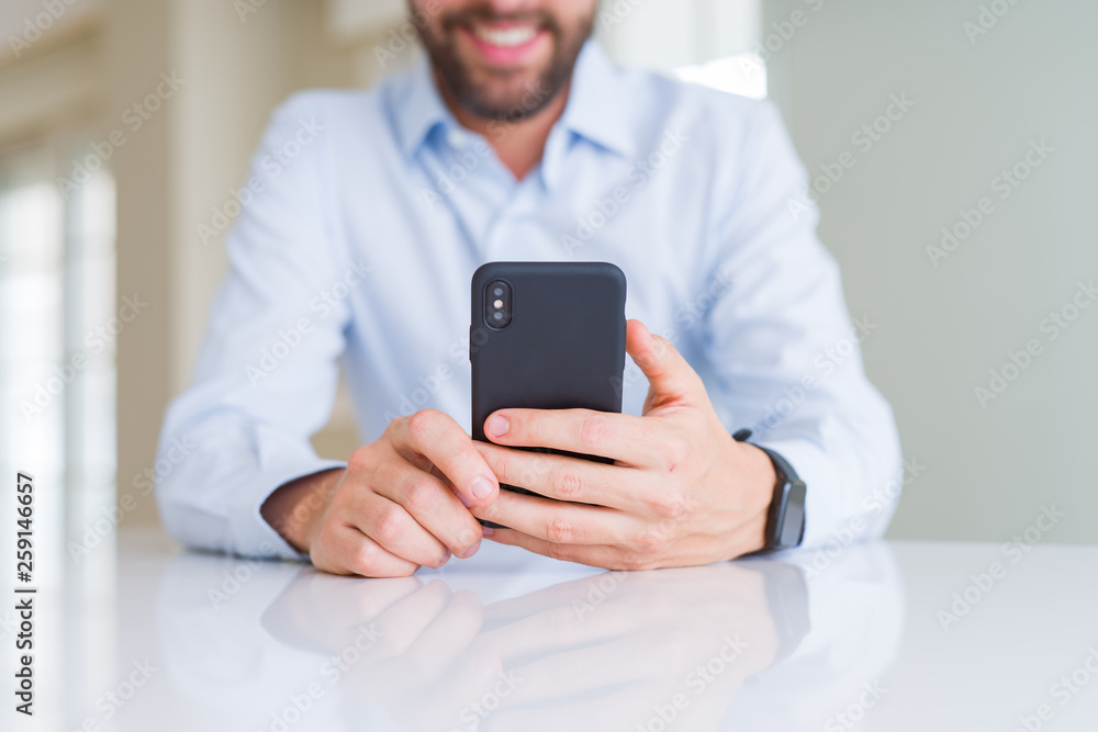 Close up of man hands using smartphone and smiling