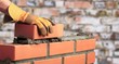 © BillionPhotos.com - Worker builds a brick wall in the