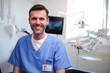 © gpointstudio - Portrait of smiling dentist in dentist's office