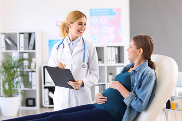 Wall Mural - Young pregnant woman visiting her gynecologist in clinic