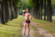 © Olga Mishyna - sport girl making exercises outdoors. Young sport woman in a park. Sport and fitness on open air. Exercise lunge leg on the grass and stretching