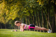 © Olga Mishyna - sport girl making exercises outdoors. Young sport woman in a park. Sport and fitness on open air. Exercise lunge leg on the grass and stretching