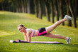 © Olga Mishyna - sport girl making exercises outdoors. Young sport woman in a park. Sport and fitness on open air. Exercise lunge leg on the grass and stretching