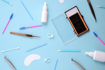 Wall Mural - makeup brushes and cosmetics on a blue background. Top view, flat lay