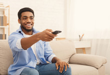 Young African-american Man Watching TV At Home