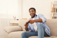 Young Man Playing Video Games At Home