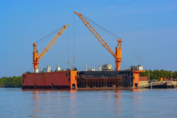 Poster - Submersible floating dry dock with dock cranes moored at river bank. Guinea, West Africa.