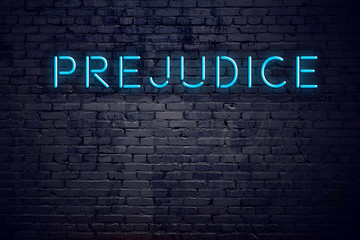 Wall Mural - Brick wall and neon sign with text prejudice