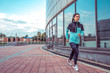© byswat - Woman girl in summer jogging in city, sportswear windbreaker leggings. Free space for text. In the morning, a sport workout. Motivation sports, lifestyle. Active lifestyle.