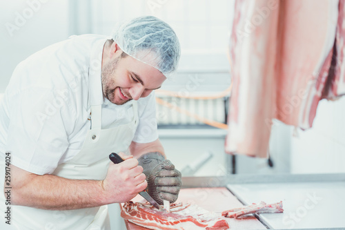 Cuadros en Lienzo Meat being processed in a butchery by man