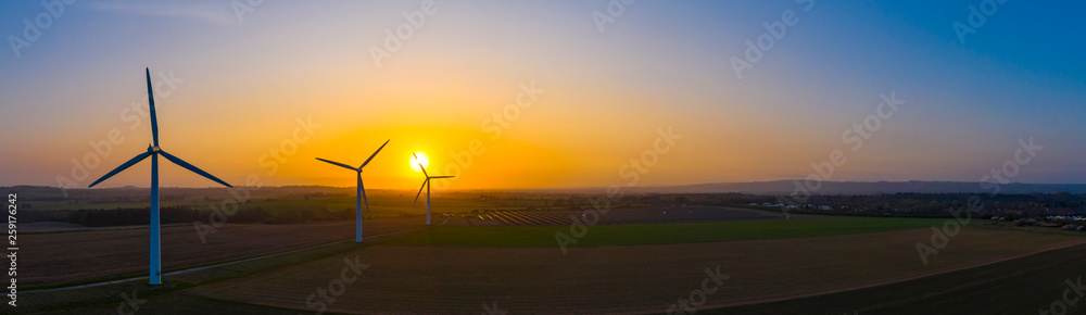 Aerial view of a wind farm during a dramatic sunrise in the English countryside, England panoramic - obrazy, fototapety, plakaty 