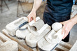 © rh2010 - Male worker getting clay products from the gypsum forms at the pottery manufacturing, close-up view