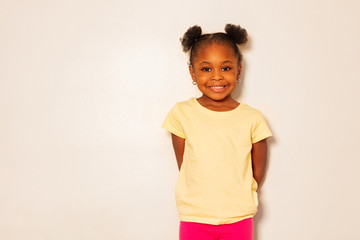 portrait of nice little black girl smile over wall